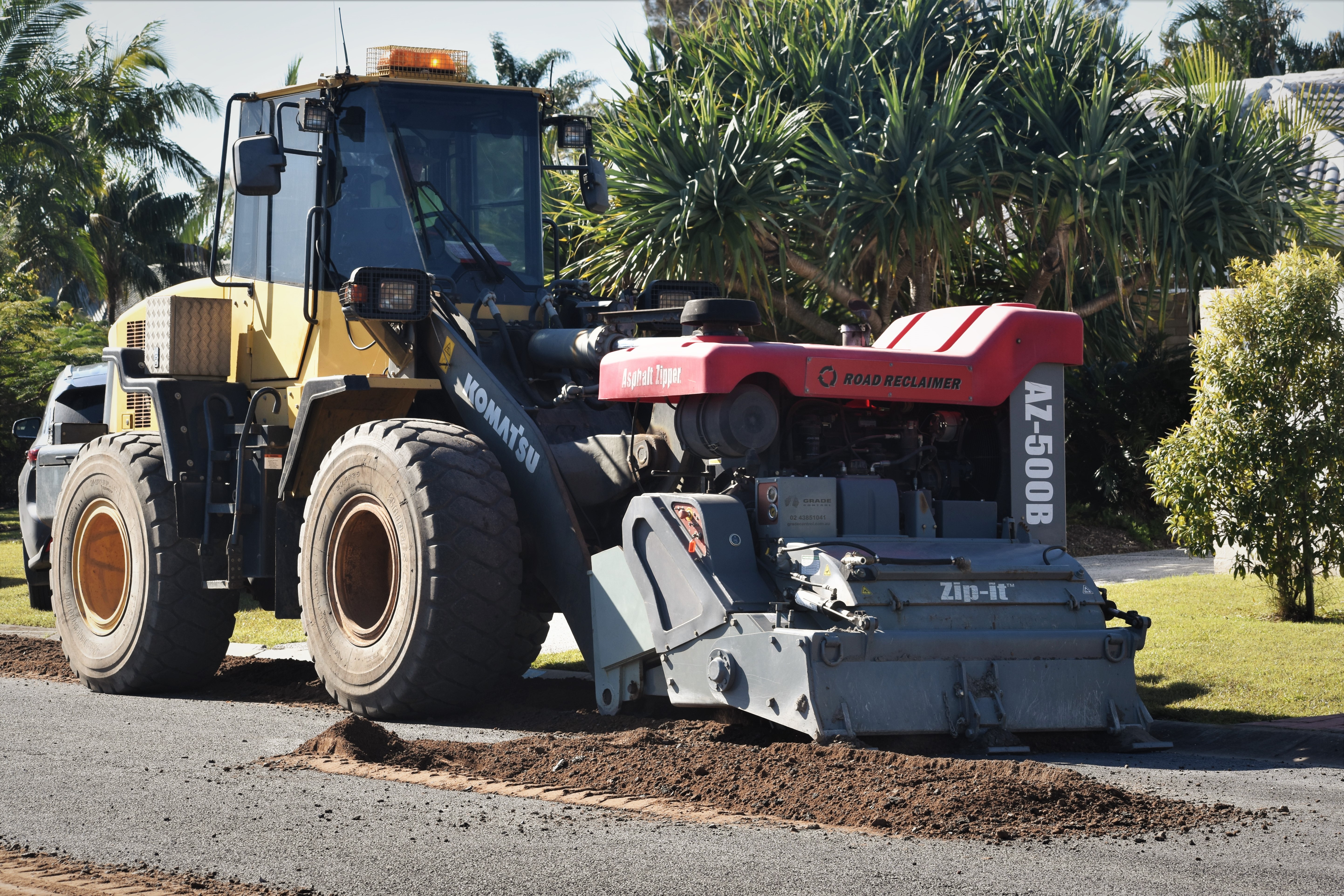 The versatile Asphalt Zipper attaches to Council's own loaders.